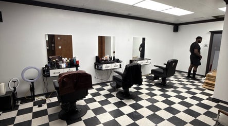 Chic interior of Carlos the Barber in Medicine Hat, Alberta, CA with modern barber chairs and equipment.