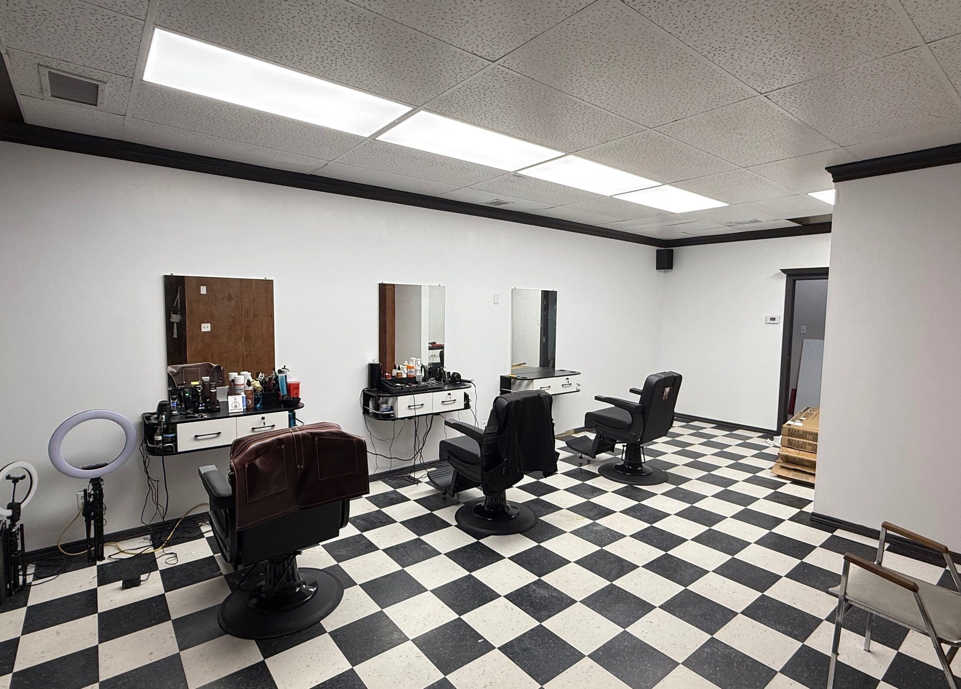 Spacious interior of Carlos the barber at Good fellas barbershop, Medicine Hat, Alberta, CA with stylish chairs.
