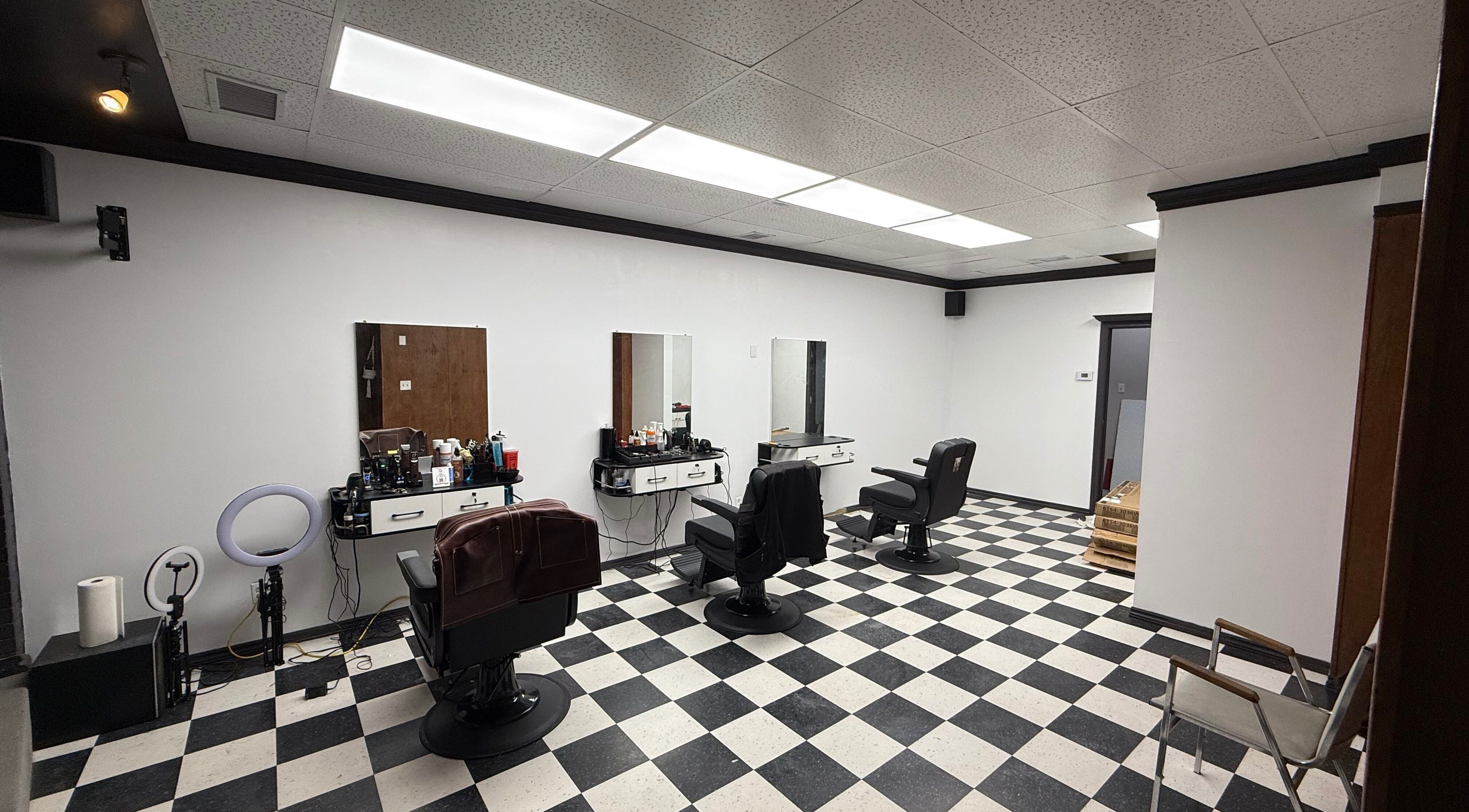 Spacious interior of Carlos the barber at Good fellas barbershop, Medicine Hat, Alberta, CA with stylish chairs.