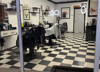 Interior of Carlos the barber at Good Fellas Barbershop in Medicine Hat, Alberta, CA with sleek styling stations.