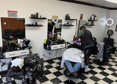 Carlos the barber at Good Fellas Barbershop in Medicine Hat, Alberta, CA skillfully tending to a client.