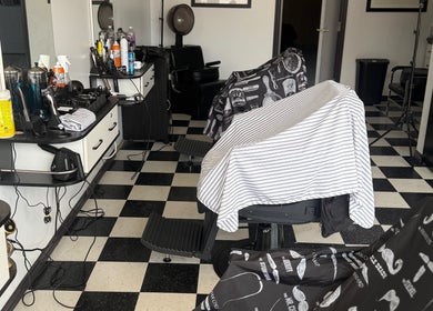 Interior of Good Fellas Barbershop in Medicine Hat, Alberta, CA. Carlos the barber's station with tools displayed.