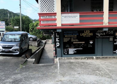 Exterior of Divine Locs & Strands, Gros Islet, showcasing LED lighting offerings.
