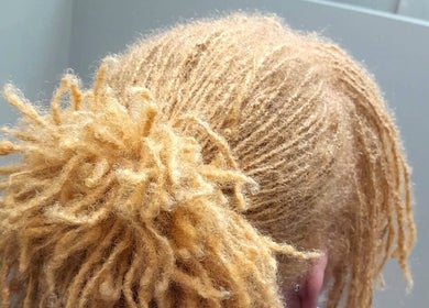 Close-up of golden dreadlocks styled at Divine Locs & Strands, Gros Islet, Gros Islet, LC.
