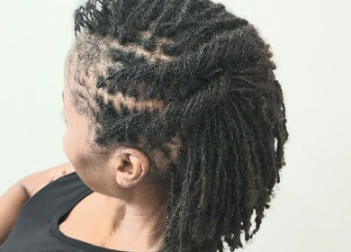 Stylish locs hairstyle at Divine Locs & Strands, Gros Islet, LC. Perfect blend of beauty and wellness.
