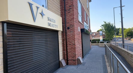 Exterior of V+ Nails Brinsworth, located in Brinsworth, England, GB, showcasing brick and modern signage.