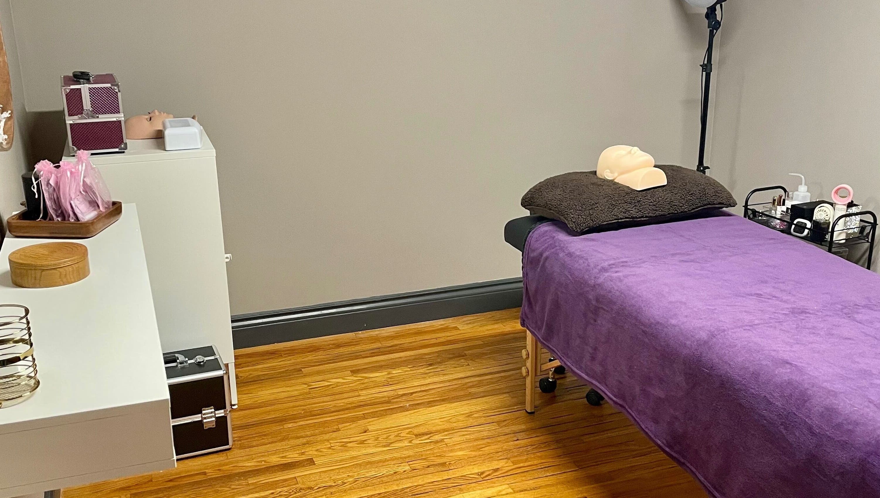 Treatment room at Velvet Eclipse, London, Ontario, CA featuring a massage table with purple cover.