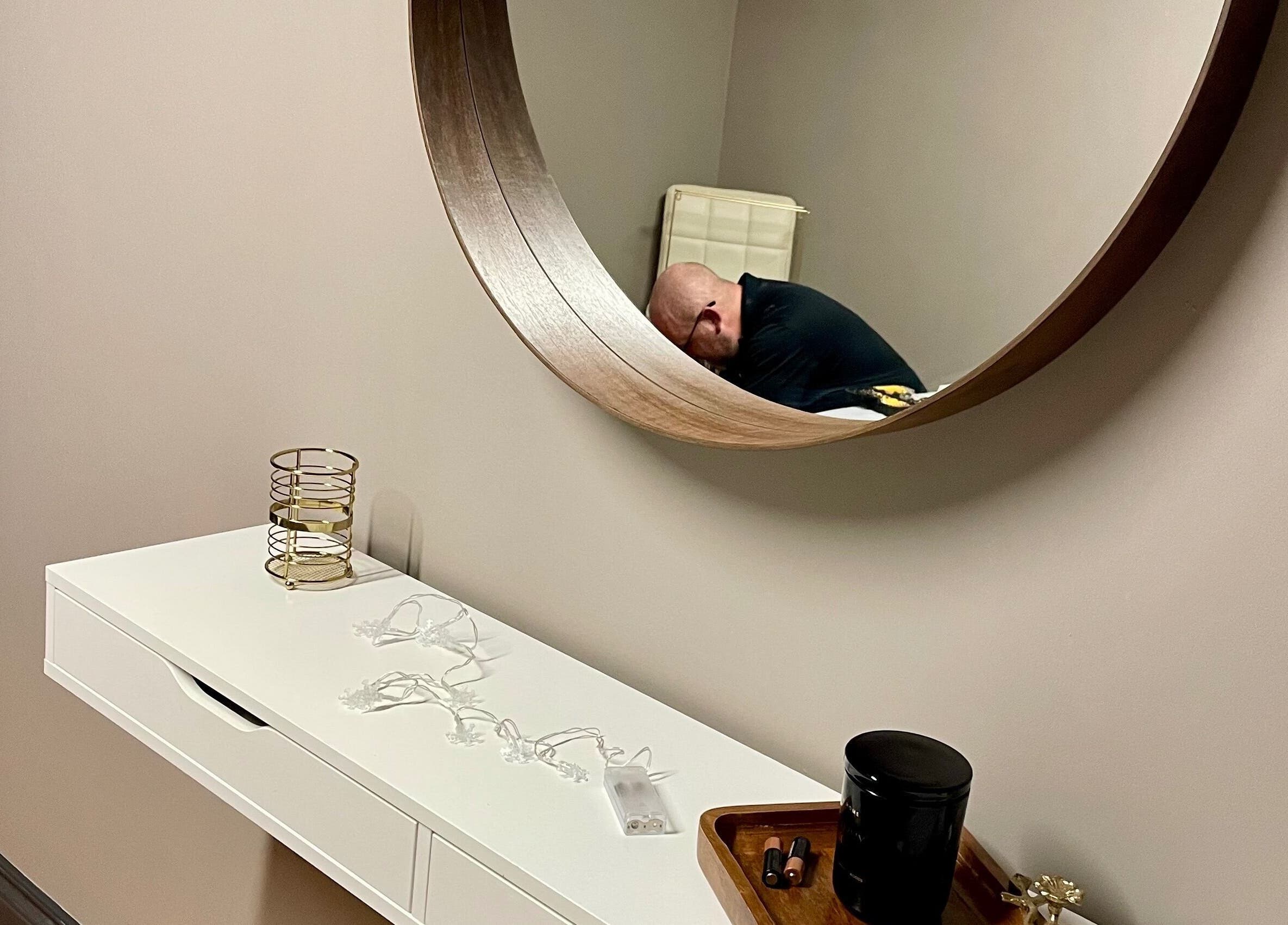 Modern decor with a circular mirror at Velvet Eclipse, London, Ontario, CA. A relaxing wellness ambience.