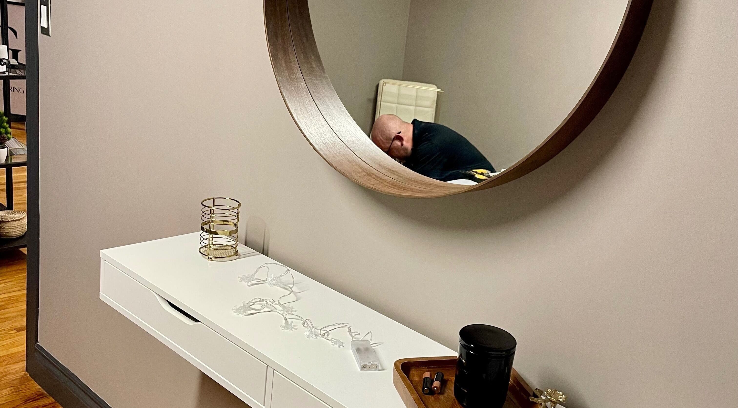 Modern decor with a circular mirror at Velvet Eclipse, London, Ontario, CA. A relaxing wellness ambience.