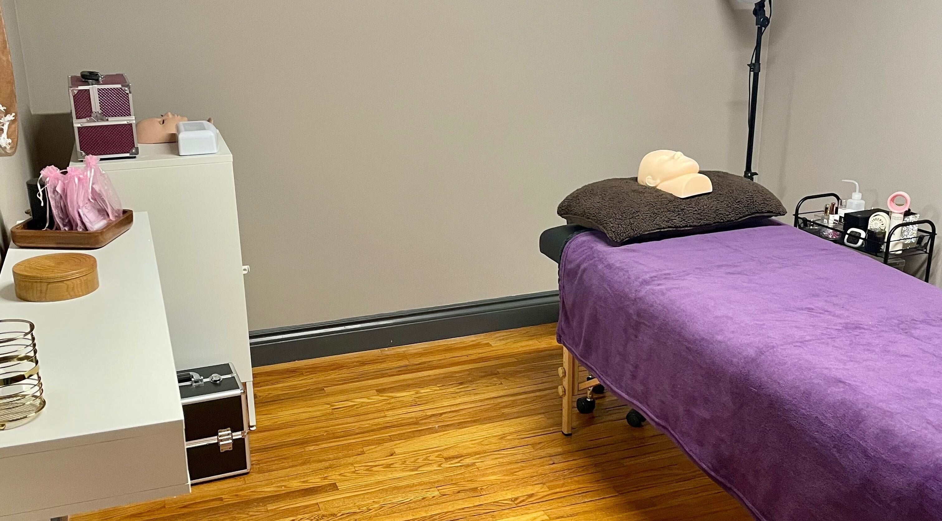 Calm treatment room at Velvet Eclipse in London, Ontario, CA with a purple bed and gentle lighting.