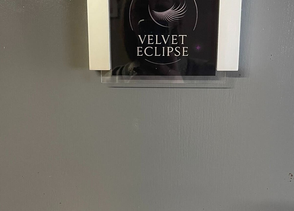 Velvet Eclipse door sign at wellness venue in London, Ontario, CA, showcasing elegant branding.