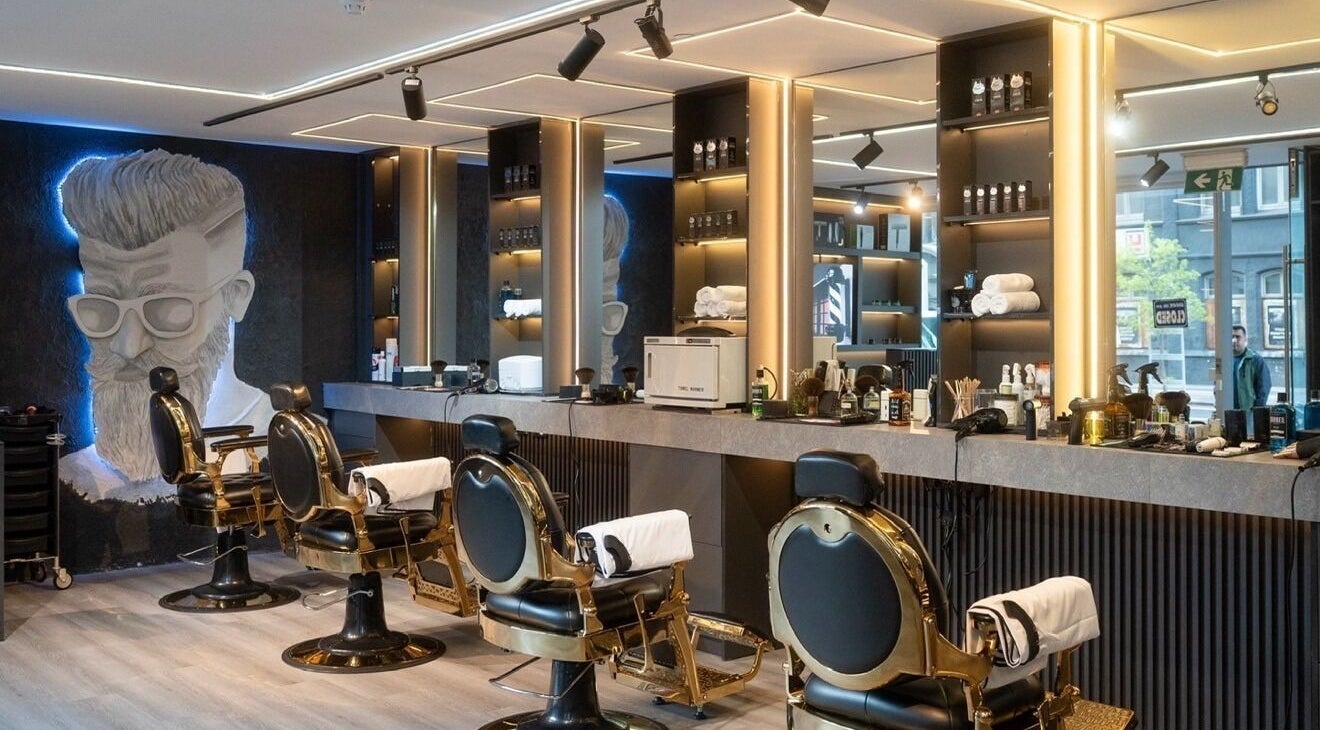 Modern interior of H50 Barbers in Southbank, Victoria, AU with chic barber chairs and illuminated decor.