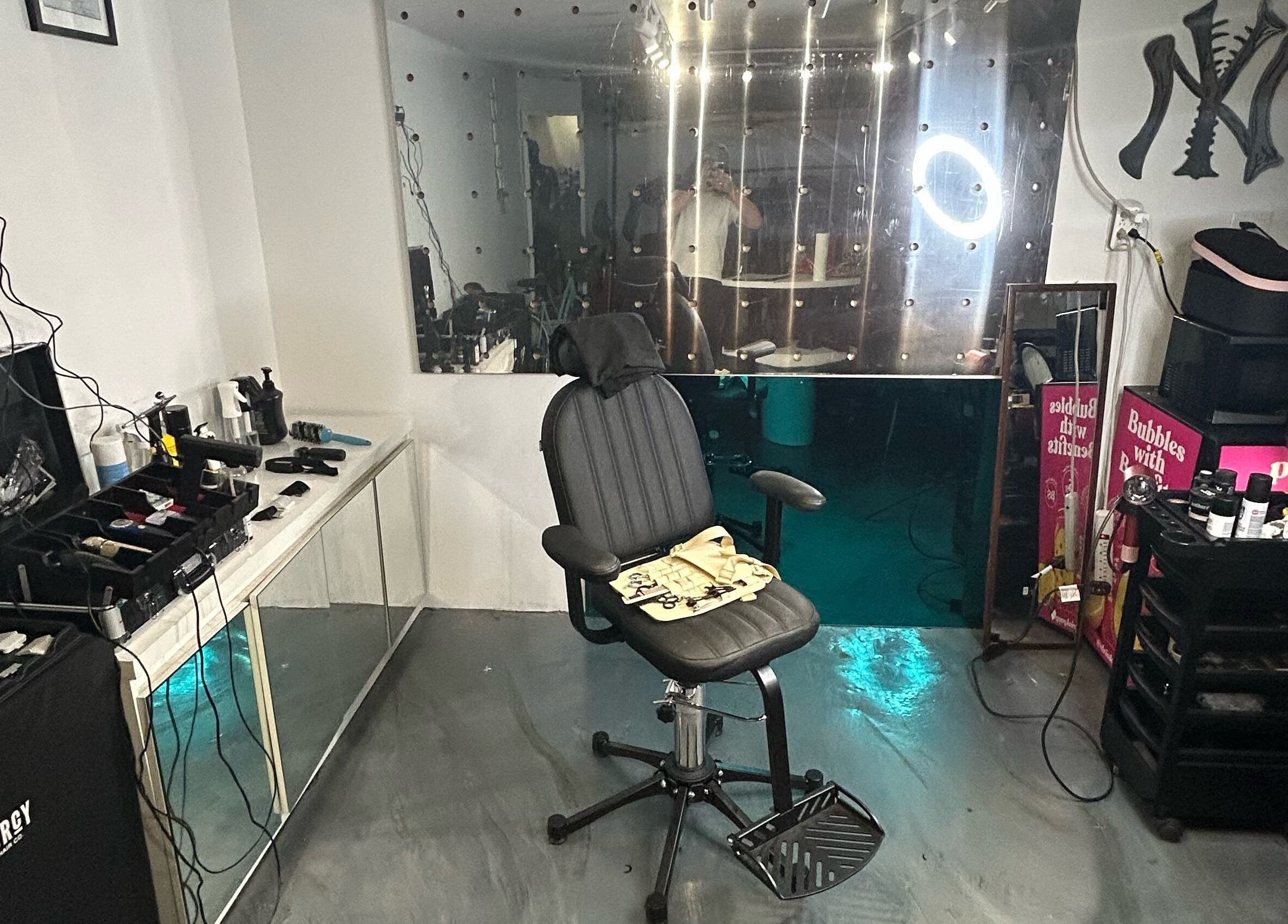 Modern salon chair and equipment setup at Cutbycaleb in New York, New York, US, showing sleek and organized space.