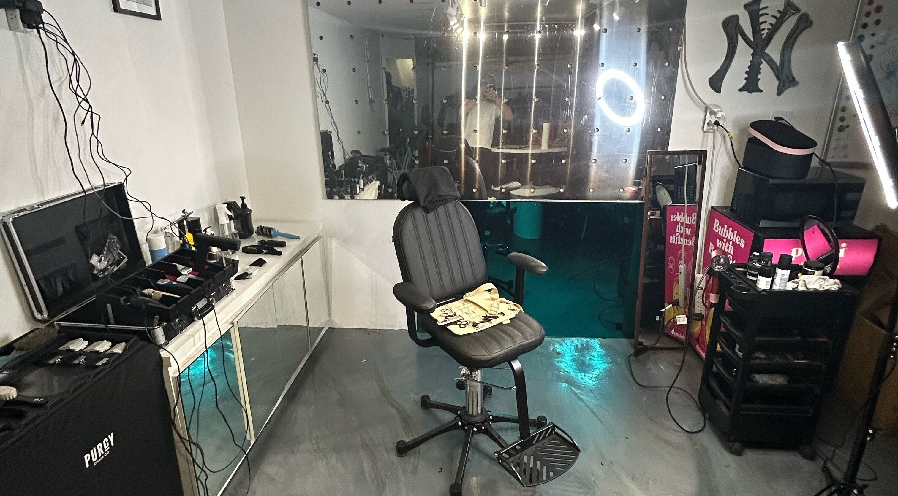 Modern salon chair and equipment setup at Cutbycaleb in New York, New York, US, showing sleek and organized space.