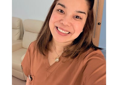 Friendly staff member at M Third Place by Mally, London, England, GB, offering a welcoming smile.