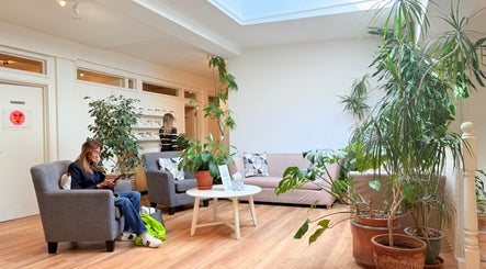 Bright seating area with plants at M Third Place by Mally in London, England, GB, offering a relaxing atmosphere.