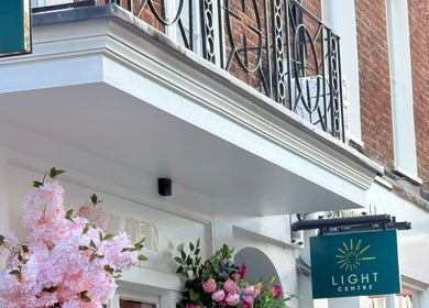 Entrance of M Third Place by Mally adorned with pink blossoms, London, England, GB.