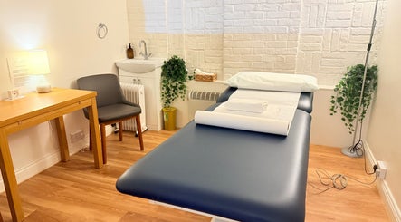 Peaceful spa room at M Third Place by Mally in London, England, GB, featuring a treatment bed and calming decor.