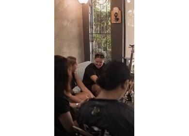 Friendly gathering at ATMA TATTOO STUDIO, Mandaue, Central Visayas, PH. People socializing in cozy setting.