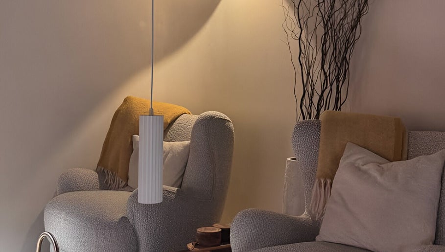 Relaxing seating area at SolBeauty Studio Newstead, Queensland, AU with plush chairs and warm lighting.