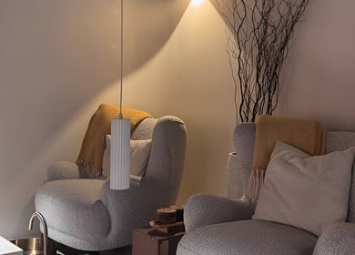 Relaxing seating area at SolBeauty Studio Newstead, Queensland, AU with plush chairs and warm lighting.