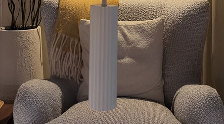 Elegant grey armchair with yellow throw at SolBeauty Studio Newstead, Newstead, Queensland, AU.