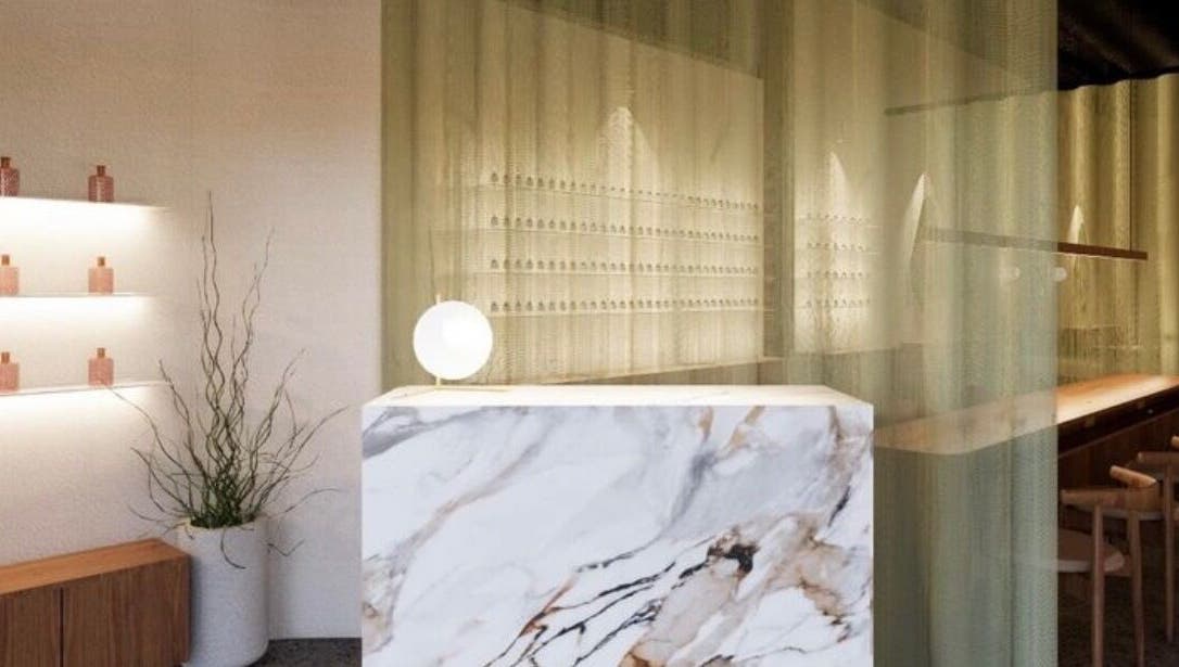 Elegant reception area at SolBeauty Studio Newstead, Queensland, AU with marble decor and ambient lighting.