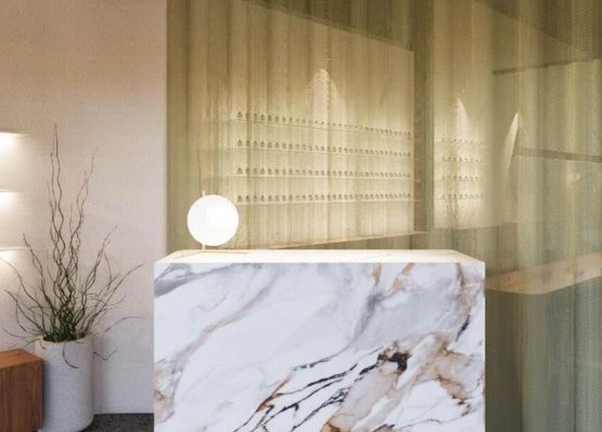 Elegant reception area at SolBeauty Studio Newstead, Queensland, AU with marble decor and ambient lighting.