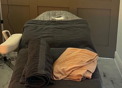 Relaxing massage table setup at Revive Massage in Norwich, England, GB, with plush towels and soothing decor.