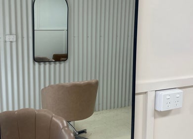 Elegant mirror and chair setup at Studio SYLK, Melbourne, Victoria, AU, showcasing modern interior design.