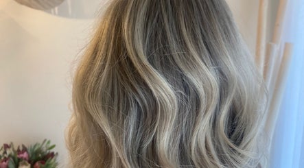 Elegant blonde waves styled at Studio SYLK in Melbourne, Victoria, AU, showcasing expert hair design.