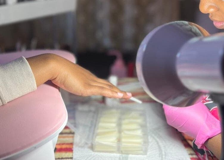 Expert manicure service at Quickly Polished By Petro in Parys, Free State, ZA, showcasing a client hand under lamp.