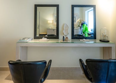 Chic salon station at Aroma Spa, Riyadh, Riyadh Province, SA showcasing luxury beauty chairs and mirrors.