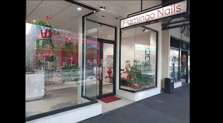 Entrance of Flamingo Nails Nelson with bright sign and plants in Nelson, Nelson Region, NZ.