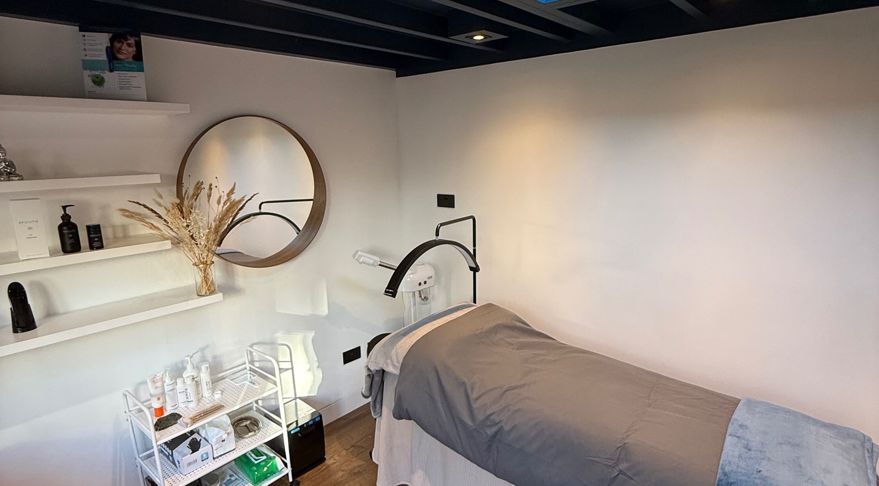 Relaxing treatment room at Kavanagh-Rose Skin, Long Ditton, England, GB with a cozy bed and elegant decor.