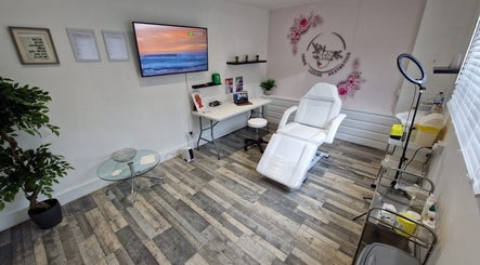 Interior of Janie Louise Aesthetics & Beauty, Burton Upon Trent, England, GB, featuring a modern treatment chair.