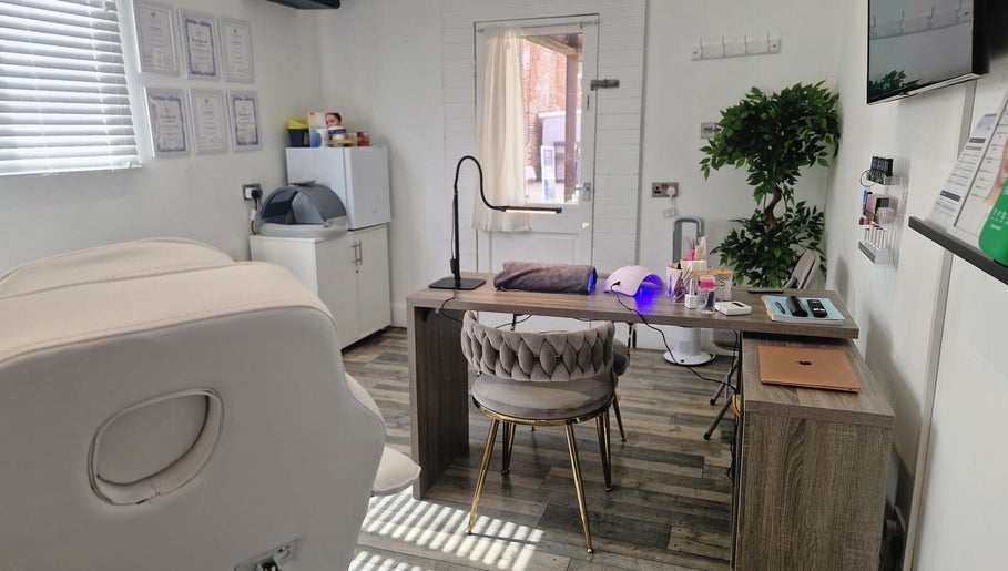 Cozy treatment room at Janie Louise Aesthetics & Beauty, Burton Upon Trent, England, GB featuring elegant decor.