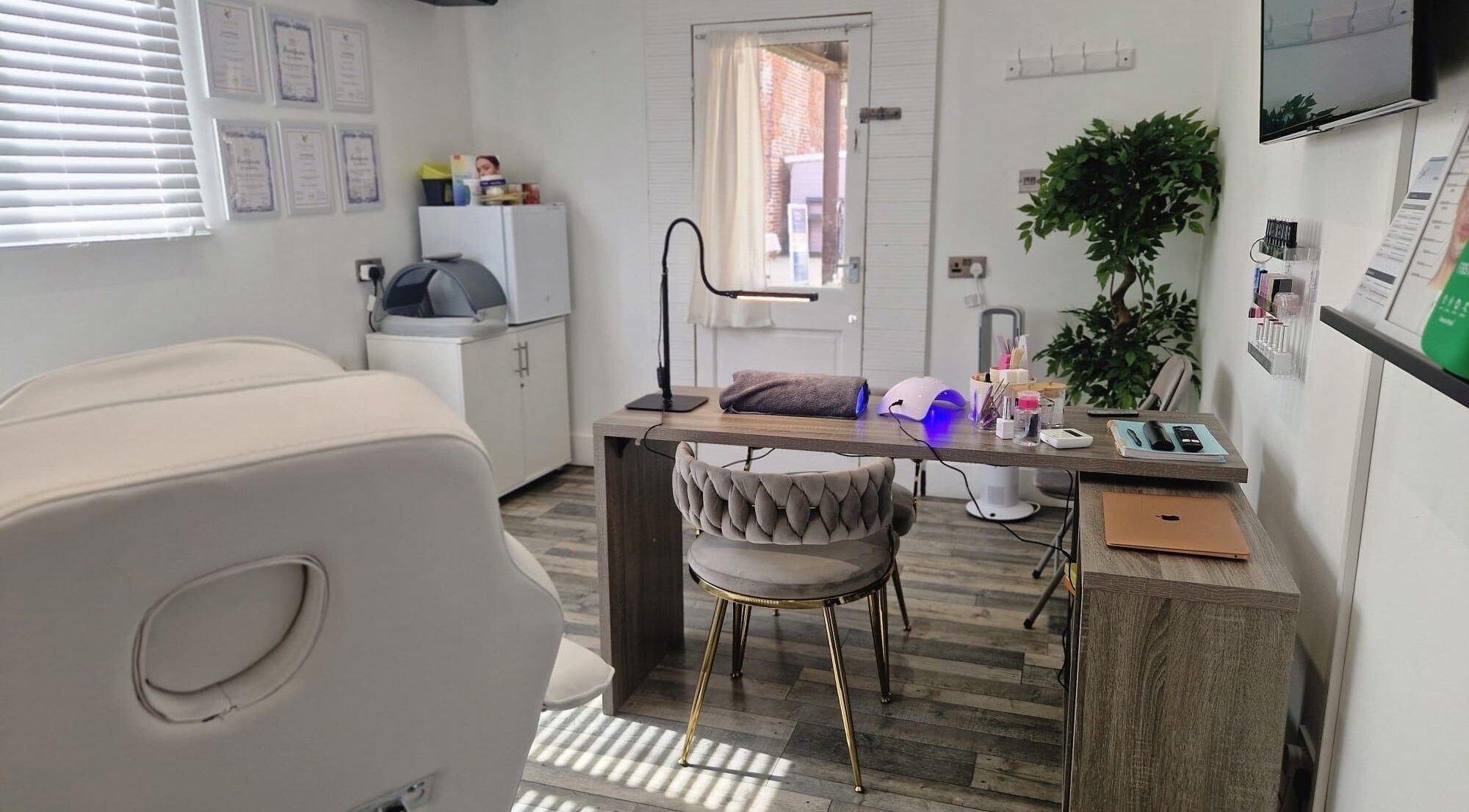 Cozy treatment room at Janie Louise Aesthetics & Beauty, Burton Upon Trent, England, GB featuring elegant decor.