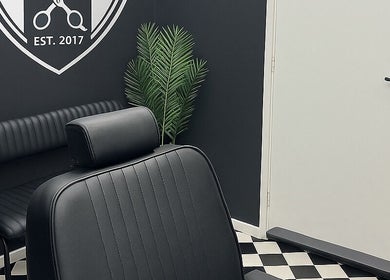 Modern black barber chair and decor at Rascal’s Barber Studio, Corby, England, GB.
