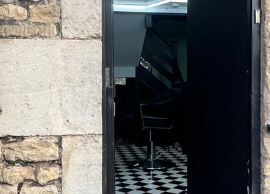 Entrance of Rascal’s Barber Studio in Corby, England, GB featuring stylish black and white decor.