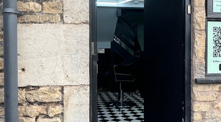 Entrance of Rascal’s Barber Studio in Corby, England, GB featuring stylish black and white decor.