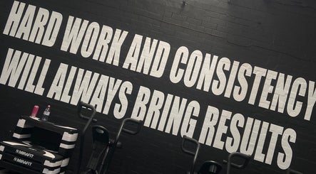 Motivational wall text at Evolve with Nicole, Denton, England, GB, inspiring hard work and fitness.