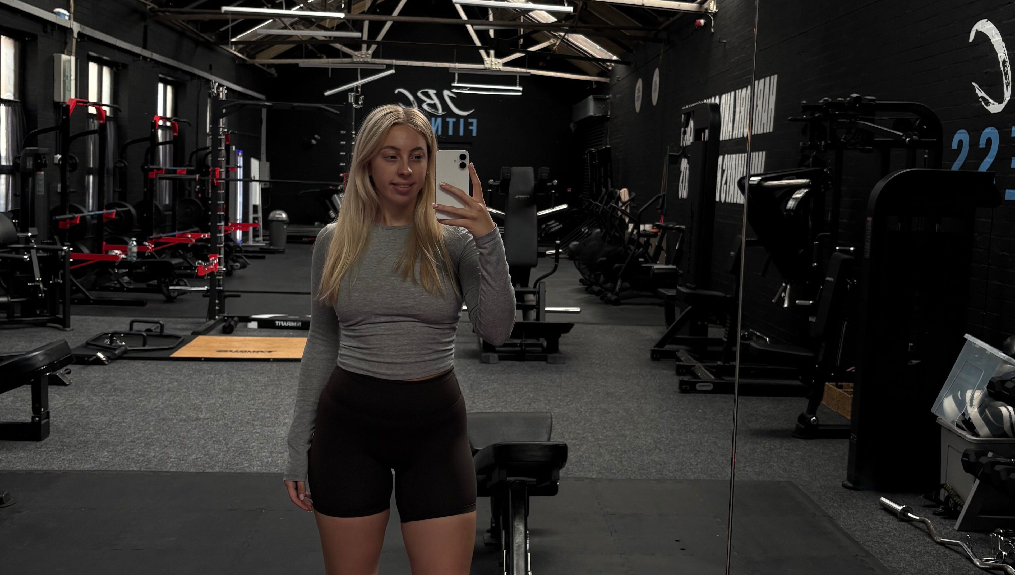 Spacious gym at Evolve with Nicole, Denton, England, GB, featuring modern equipment and large mirrors.