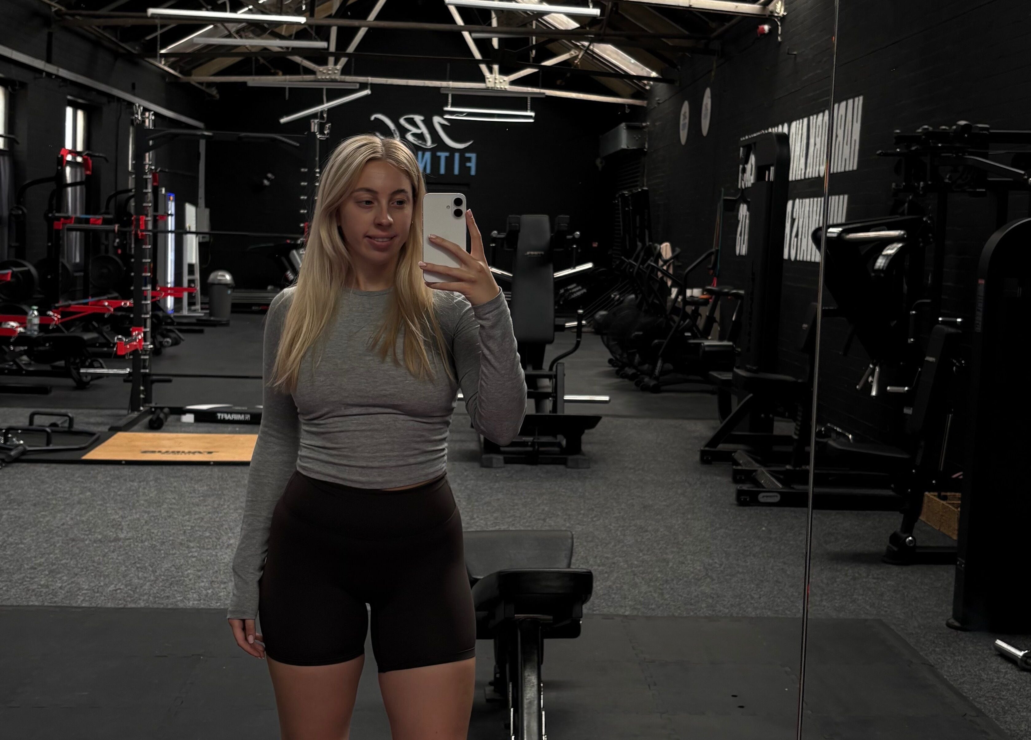 Spacious gym at Evolve with Nicole, Denton, England, GB, featuring modern equipment and large mirrors.