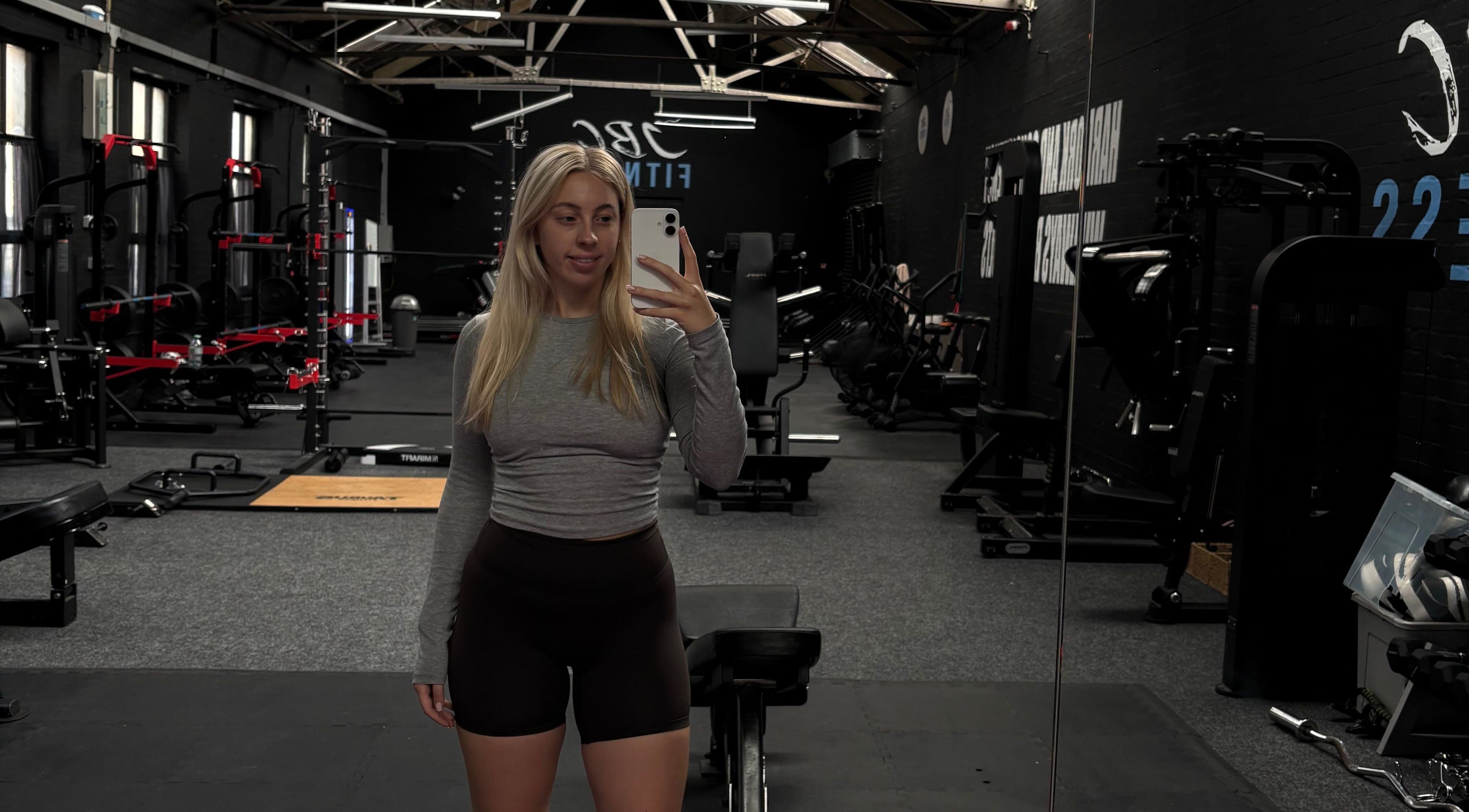 Spacious gym at Evolve with Nicole, Denton, England, GB, featuring modern equipment and large mirrors.