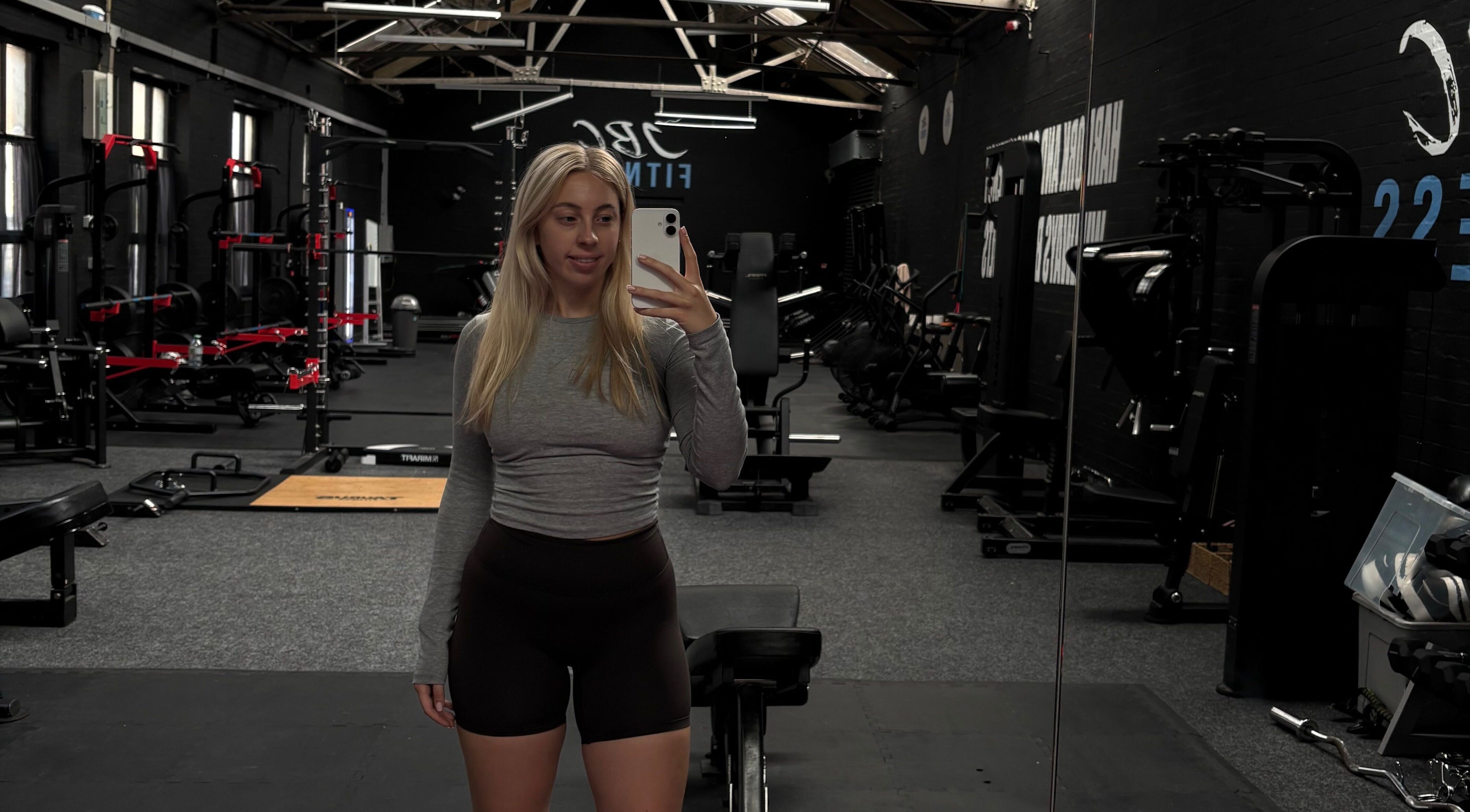 Spacious gym at Evolve with Nicole, Denton, England, GB, featuring modern equipment and large mirrors.