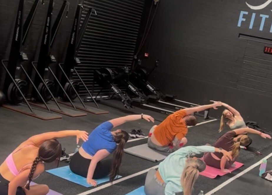 Participants engaged in a yoga class at Evolve with Nicole, Denton, England, GB, enhancing flexibility.