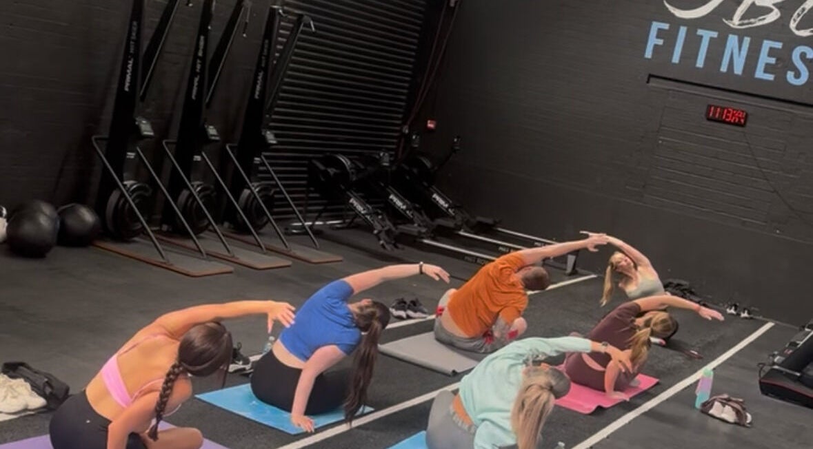 Participants engaged in a yoga class at Evolve with Nicole, Denton, England, GB, enhancing flexibility.