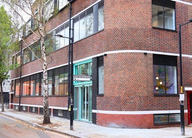 Exterior view of Queens LDN, a modern brick building in London, England, GB, highlighting its sleek design.