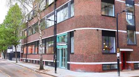 Exterior view of Queens LDN, a modern brick building in London, England, GB, highlighting its sleek design.